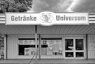 1295 (2) Schwarz-Weiss Fotografie - Laden in Dmitz / Elbe; Schild Getrnke Universum - Atomsymbol, Umlaufbahn von Elektronen eines Atoms um den Kern - hier Bierglas.